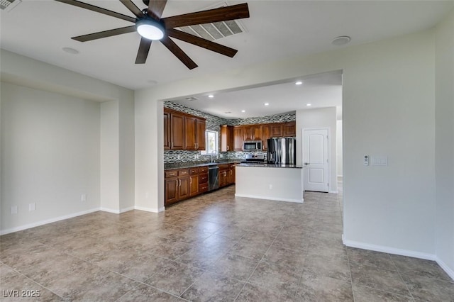 kitchen featuring a kitchen island, baseboards, open floor plan, appliances with stainless steel finishes, and backsplash