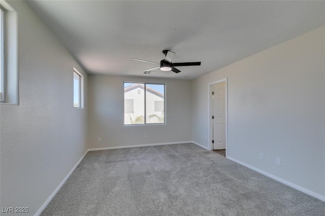 unfurnished room featuring light carpet, ceiling fan, and baseboards