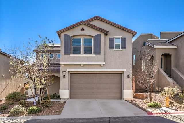 view of front of house with driveway, an attached garage, a tiled roof, and stucco siding