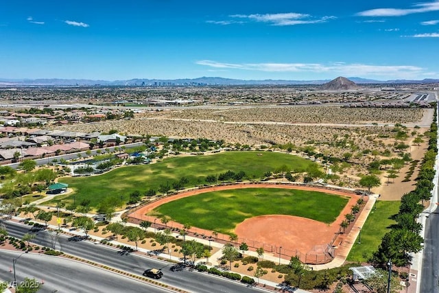 drone / aerial view with a mountain view and golf course view