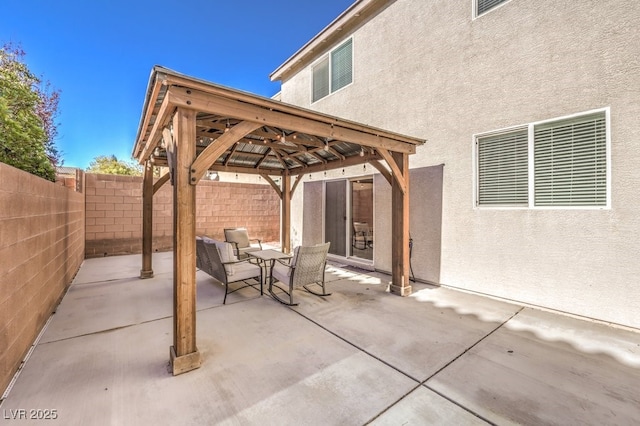 view of patio with a fenced backyard and a gazebo