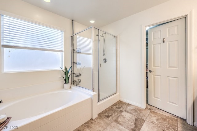 bathroom with a shower stall and a bath