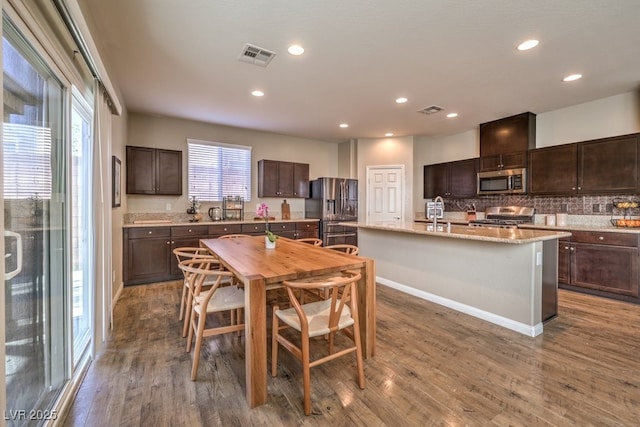 dining room featuring visible vents, wood finished floors, and recessed lighting