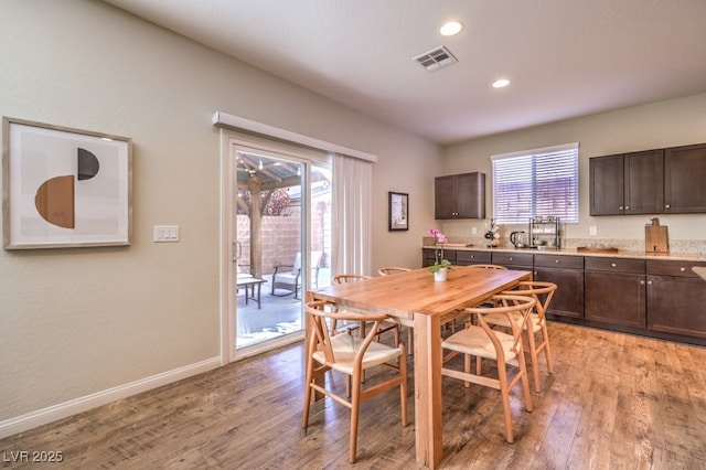 dining room featuring recessed lighting, light wood-type flooring, visible vents, and baseboards