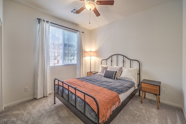 bedroom featuring baseboards, visible vents, a ceiling fan, and light colored carpet