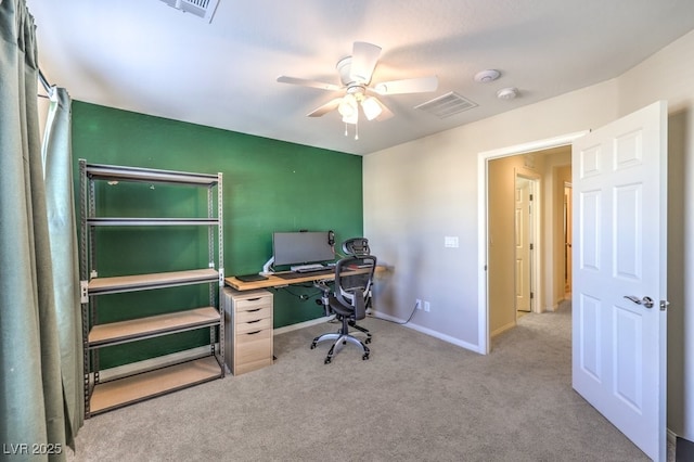 office with baseboards, ceiling fan, visible vents, and light colored carpet