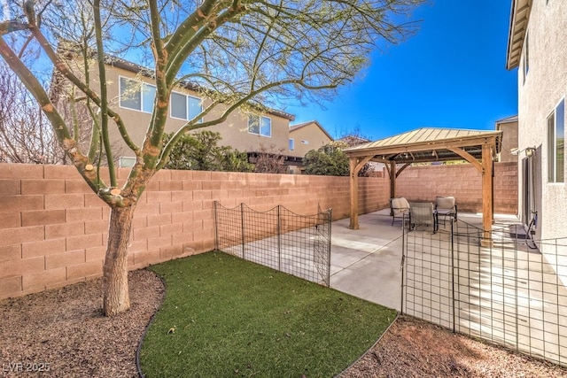 view of patio featuring a gazebo and a fenced backyard