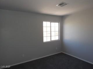 unfurnished room featuring visible vents and baseboards