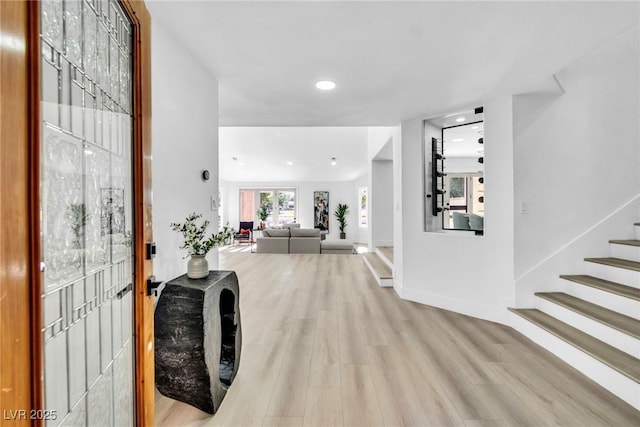 entrance foyer with light wood-style floors, recessed lighting, baseboards, and stairs