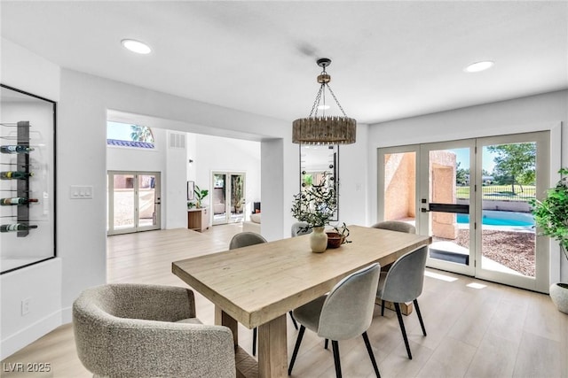 dining room with light wood-type flooring, recessed lighting, baseboards, and french doors