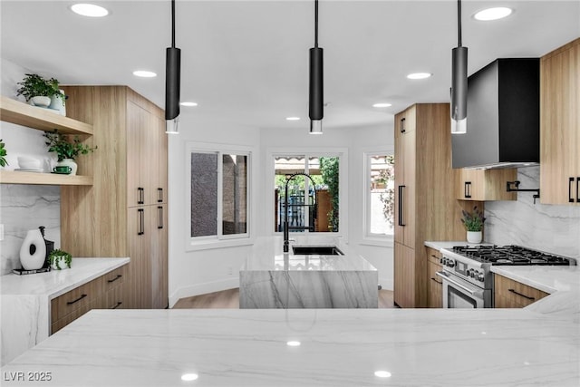 kitchen featuring decorative light fixtures, high end stainless steel range oven, a sink, and open shelves