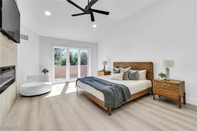 bedroom with visible vents, a ceiling fan, lofted ceiling, access to outside, and light wood-style floors