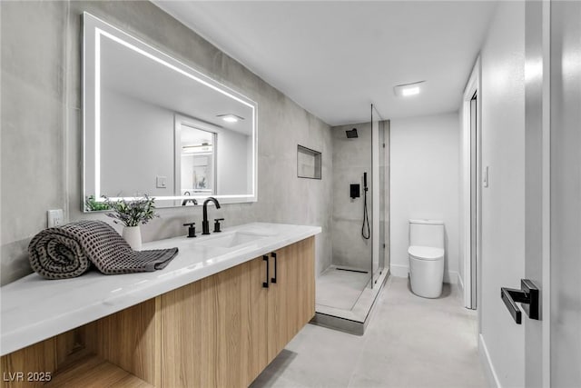 full bath with a stall shower, vanity, and toilet