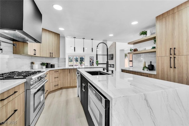 kitchen featuring stainless steel appliances, light stone countertops, open shelves, an island with sink, and modern cabinets