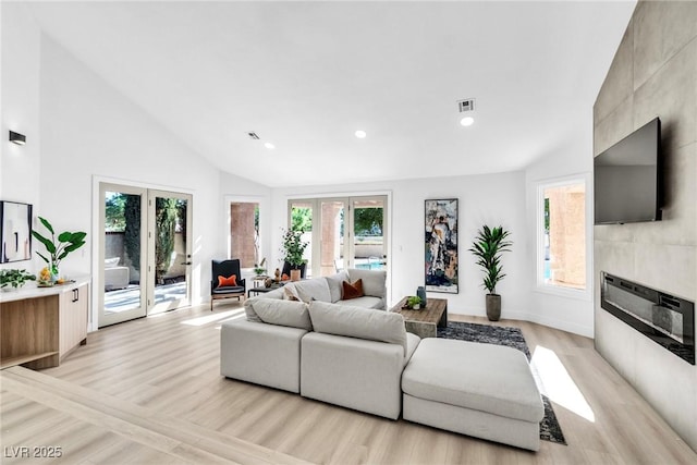 living area featuring a wealth of natural light, french doors, and visible vents