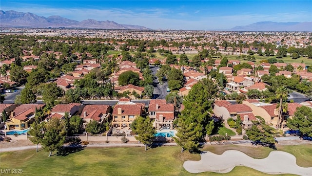 aerial view with a residential view, a mountain view, and golf course view