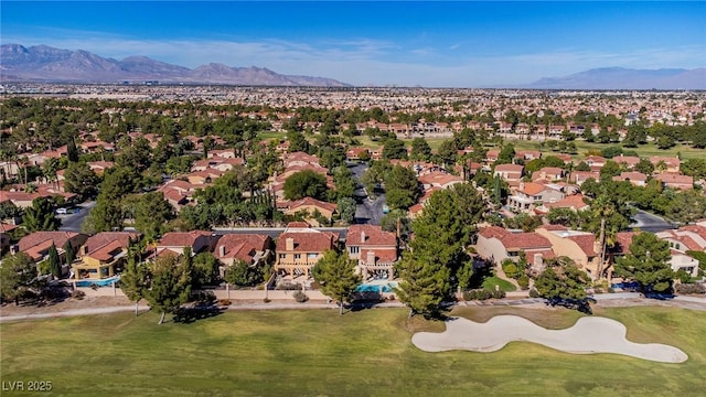 drone / aerial view with a residential view, a mountain view, and golf course view