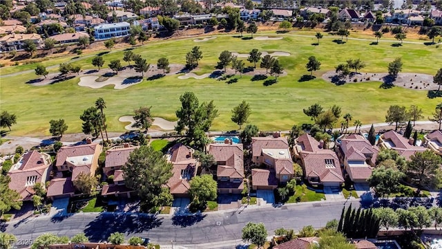 drone / aerial view with golf course view and a residential view