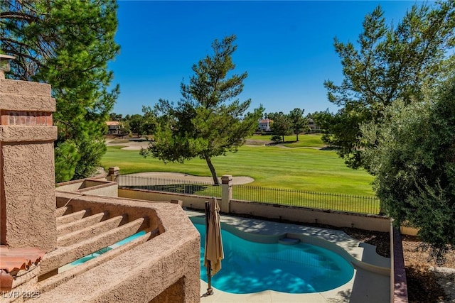 exterior space featuring view of golf course, a yard, and fence