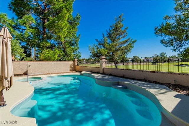 view of swimming pool featuring a fenced backyard and a pool with connected hot tub