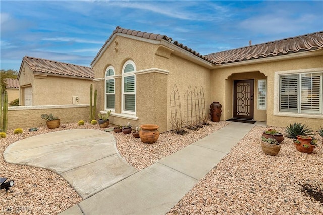 view of exterior entry with stucco siding