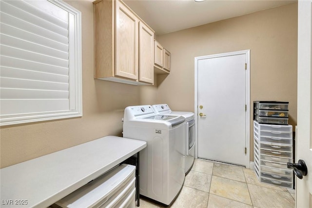 washroom with washer and dryer, cabinet space, and light tile patterned floors