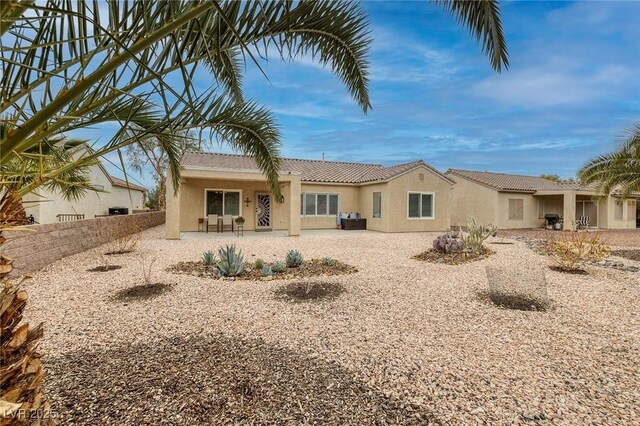 back of house with a patio area, stucco siding, and fence