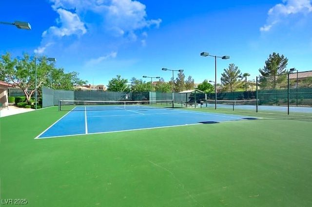 view of tennis court with fence