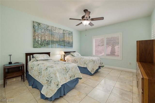 bedroom with light tile patterned floors, baseboards, and ceiling fan