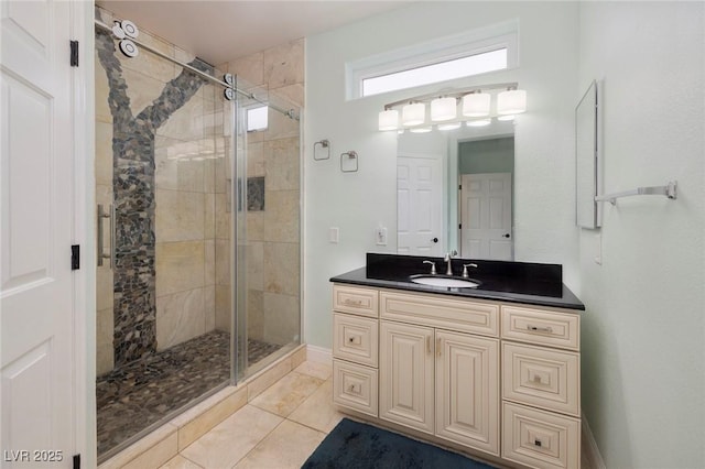 bathroom featuring vanity, a shower stall, and tile patterned flooring