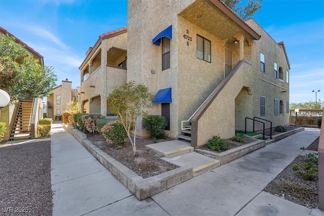 view of building exterior featuring stairs and a residential view