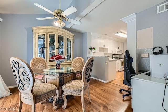 dining area with light wood finished floors, visible vents, and a ceiling fan