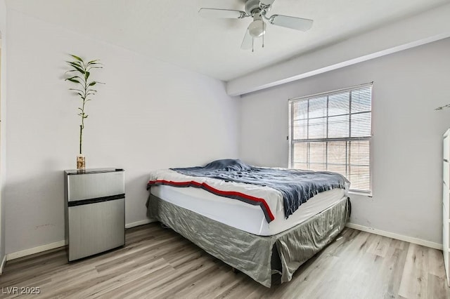 bedroom with baseboards, light wood-style floors, and a ceiling fan