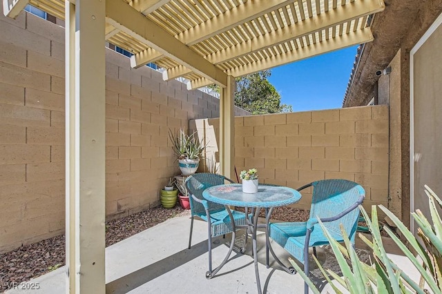 view of patio / terrace featuring outdoor dining space, fence, and a pergola