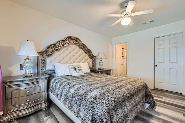 bedroom featuring wood finished floors, visible vents, and ceiling fan