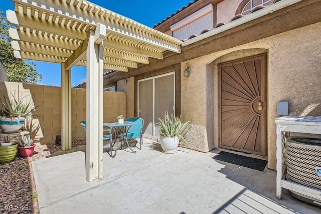 view of patio featuring a pergola and fence