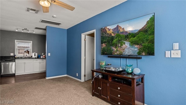 interior space featuring baseboards, a ceiling fan, visible vents, and carpet floors