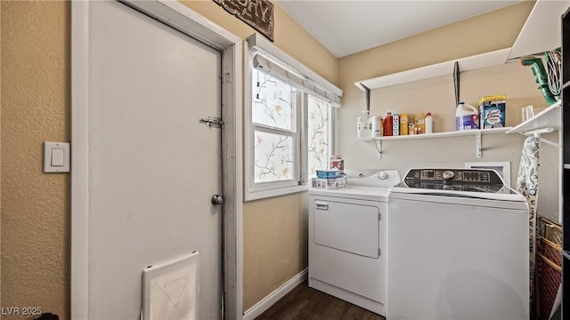 laundry area featuring washer and clothes dryer, a textured wall, dark wood finished floors, baseboards, and laundry area