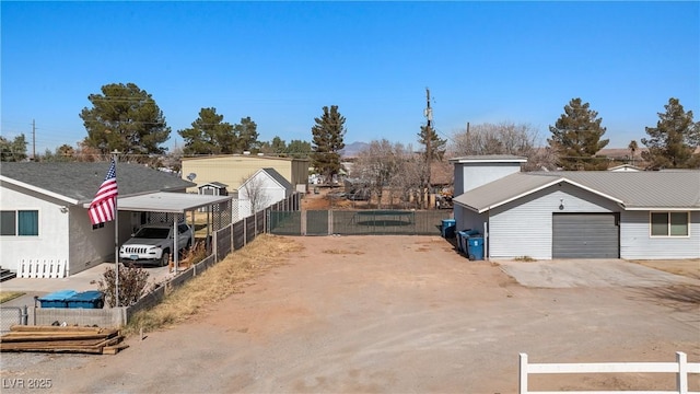 exterior space with concrete driveway, an attached garage, and fence