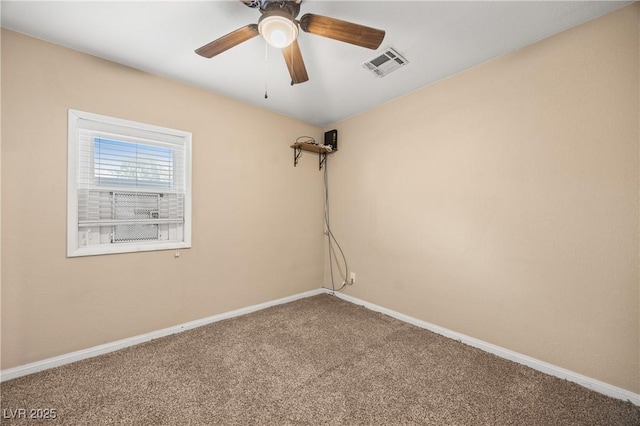 spare room with visible vents, carpet flooring, baseboards, and ceiling fan