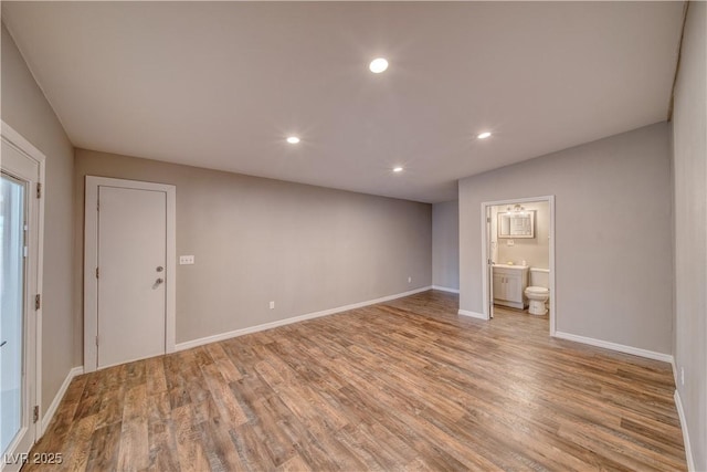 empty room featuring recessed lighting, light wood-style flooring, and baseboards