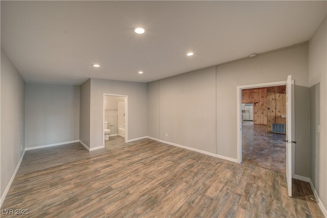 spare room featuring baseboards, dark wood-type flooring, visible vents, and recessed lighting