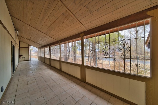 unfurnished sunroom with wood ceiling and vaulted ceiling