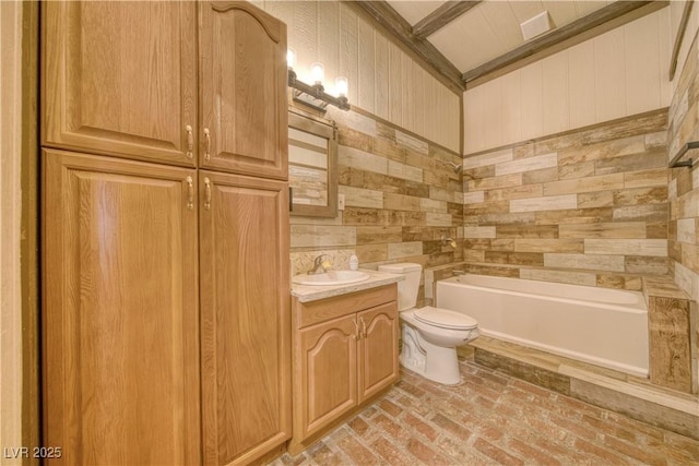 full bathroom with wooden walls, toilet, brick floor, vanity, and a bath