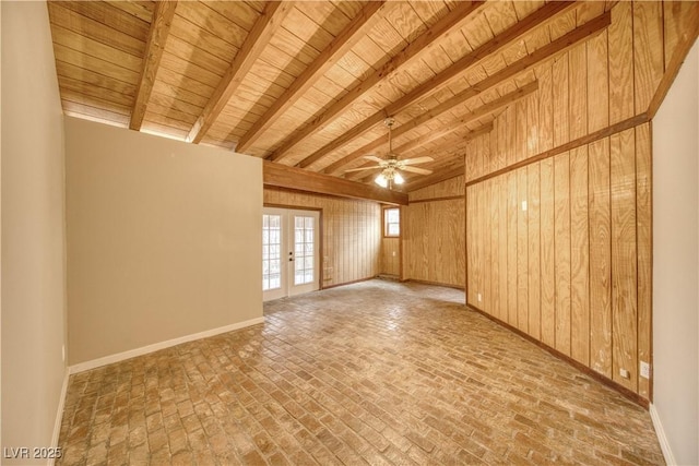 spare room with brick floor, french doors, beam ceiling, wooden walls, and wooden ceiling