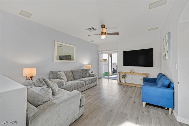 living area featuring light wood-style floors, visible vents, and ceiling fan