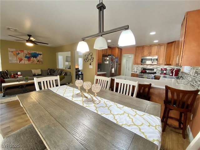 dining area featuring ceiling fan, recessed lighting, visible vents, and light wood-style floors