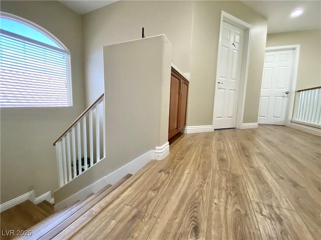 spare room featuring light wood-style flooring and baseboards