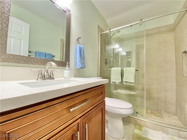 full bath with toilet, a stall shower, and vanity