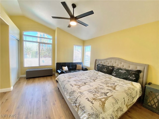 bedroom featuring lofted ceiling, wood finished floors, a ceiling fan, and baseboards